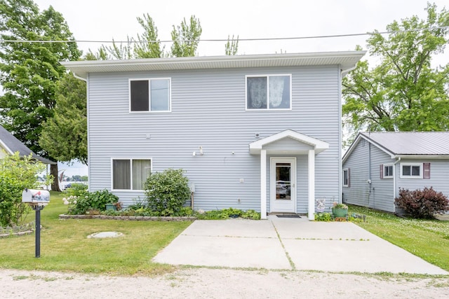 11105 Hahn Beach Dr, Evart, MI 49631 - view of front facade with a front yard and a patio area