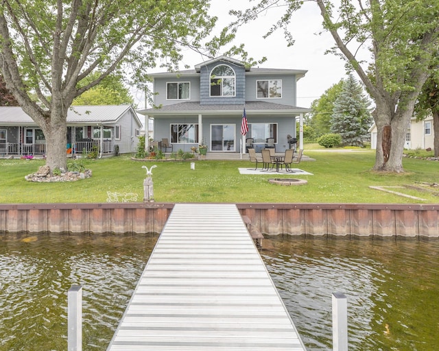 11105 Hahn Beach Dr, Evart, MI 49631 - back of property featuring a water view, a lawn, and a patio area