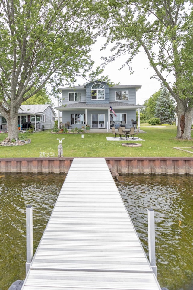 11105 Hahn Beach Dr, Evart, MI 49631 - dock area with a water view, a lawn, and a patio