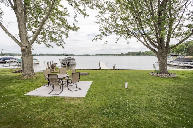 11105 Hahn Beach Dr, Evart, MI 49631 - view of green lawn featuring a boat dock, a water view, and a patio