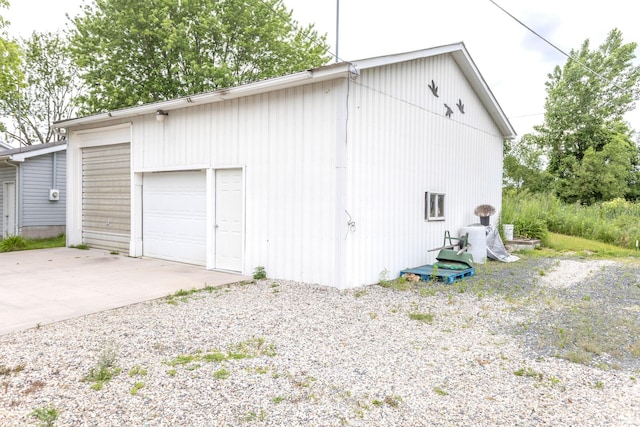 11105 Hahn Beach Dr, Evart, MI 49631 - view of property exterior featuring an outdoor structure, driveway, and a detached garage