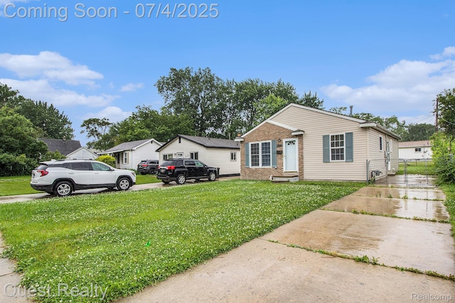 26441 Spicer St, Hazel Park, MI 48071 - view of front of house featuring brick siding, a front yard, and entry steps