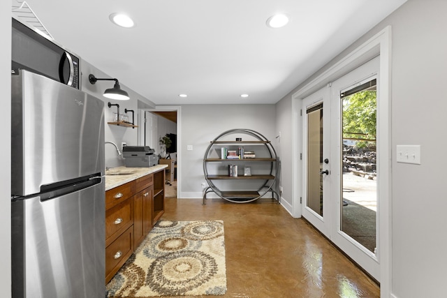 15178 154th Ave, Grand Haven, MI 49417 - kitchen with freestanding refrigerator, brown cabinetry, concrete floors, recessed lighting, and open shelves