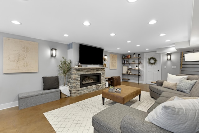 15178 154th Ave, Grand Haven, MI 49417 - living room with stairs, recessed lighting, a stone fireplace, and finished concrete floors