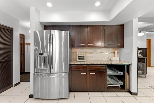 15178 154th Ave, Grand Haven, MI 49417 - kitchen featuring stainless steel refrigerator with ice dispenser, dark brown cabinets, tasteful backsplash, light stone counters, and light tile patterned floors