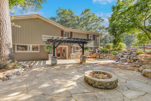 15178 154th Ave, Grand Haven, MI 49417 - view of patio / terrace with french doors, a pergola, and a fire pit