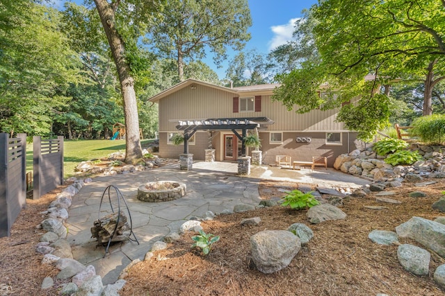 15178 154th Ave, Grand Haven, MI 49417 - view of patio with an outdoor fire pit, a pergola, and a playground