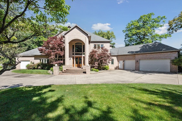 6076 Browns Lake Rd, Jackson, MI 49203 - traditional home featuring concrete driveway, a front lawn, and a garage