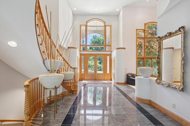 6076 Browns Lake Rd, Jackson, MI 49203 - foyer with stairway, a high ceiling, recessed lighting, marble tiled flooring, and french doors