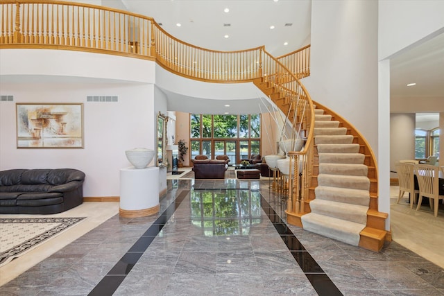 6076 Browns Lake Rd, Jackson, MI 49203 - entryway with a towering ceiling, stairs, recessed lighting, and marble tiled floors