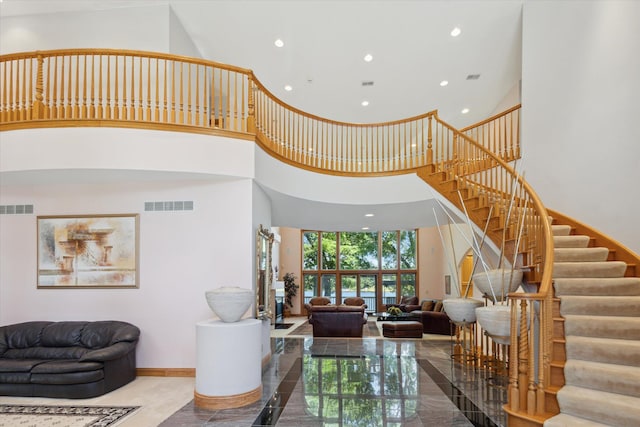 6076 Browns Lake Rd, Jackson, MI 49203 - living room with a high ceiling, recessed lighting, stairs, and marble tiled flooring