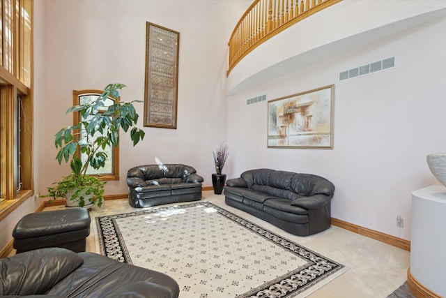 6076 Browns Lake Rd, Jackson, MI 49203 - carpeted living room with a towering ceiling and baseboards