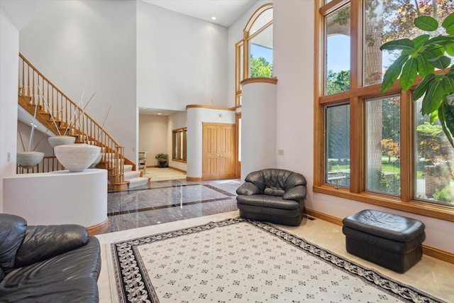 6076 Browns Lake Rd, Jackson, MI 49203 - living area with a towering ceiling, stairway, and inlaid floor details