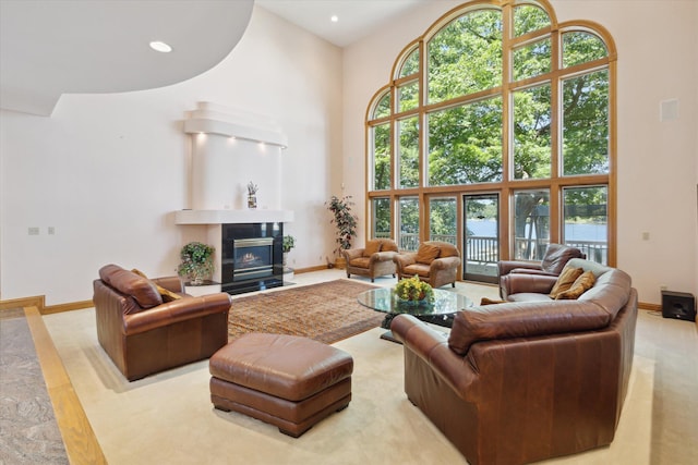 6076 Browns Lake Rd, Jackson, MI 49203 - living area with a high ceiling, a tiled fireplace, and recessed lighting
