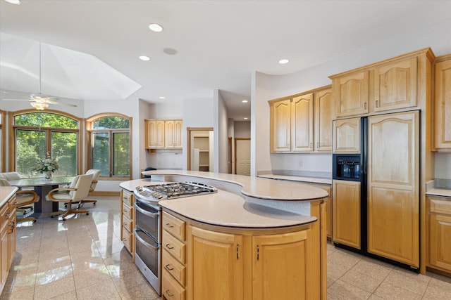 6076 Browns Lake Rd, Jackson, MI 49203 - kitchen with paneled refrigerator, double oven range, light brown cabinetry, a kitchen island, and light countertops