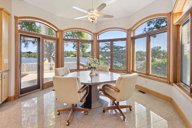 6076 Browns Lake Rd, Jackson, MI 49203 - dining area with granite floors, a water view, and a ceiling fan