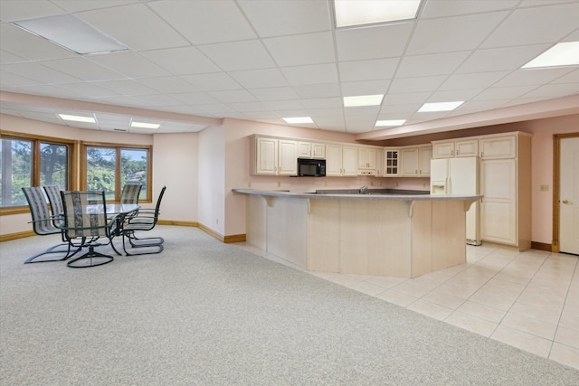 6076 Browns Lake Rd, Jackson, MI 49203 - kitchen with black microwave, white refrigerator with ice dispenser, a kitchen breakfast bar, glass insert cabinets, and a drop ceiling