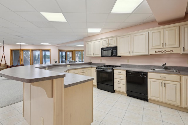 6076 Browns Lake Rd, Jackson, MI 49203 - kitchen with black appliances, a peninsula, light tile patterned flooring, a drop ceiling, and a kitchen bar