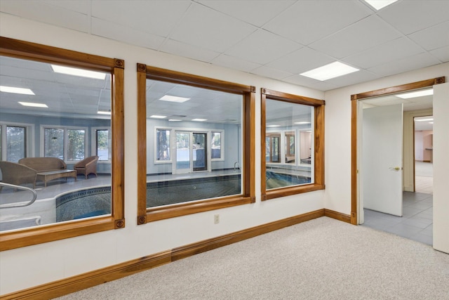 6076 Browns Lake Rd, Jackson, MI 49203 - carpeted empty room with baseboards and a drop ceiling