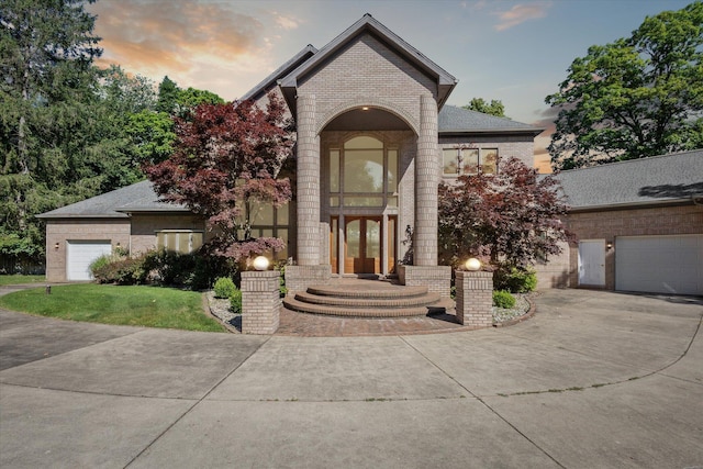 6076 Browns Lake Rd, Jackson, MI 49203 - view of front of property with brick siding, driveway, a front yard, and french doors