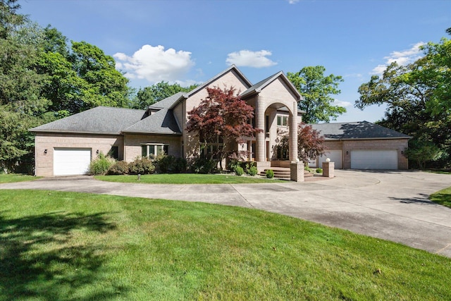 6076 Browns Lake Rd, Jackson, MI 49203 - view of front of property with a front yard, concrete driveway, and brick siding