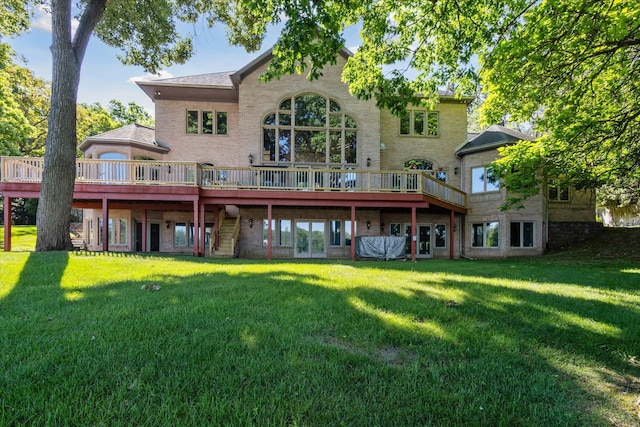 6076 Browns Lake Rd, Jackson, MI 49203 - rear view of property featuring a lawn, a deck, and brick siding