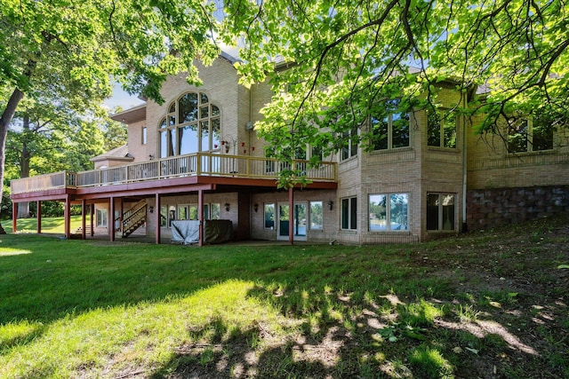 6076 Browns Lake Rd, Jackson, MI 49203 - rear view of house featuring a wooden deck, brick siding, stairs, and a lawn
