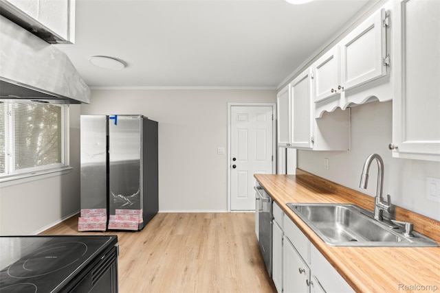 42078 Arthur St, Belleville, MI 48111 - kitchen with appliances with stainless steel finishes, white cabinetry, light wood-style flooring, butcher block countertops, and ornamental molding