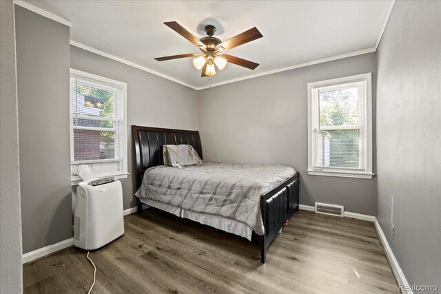 18247 Harlow St, Detroit, MI 48235 - bedroom with multiple windows, wood finished floors, ornamental molding, and ceiling fan