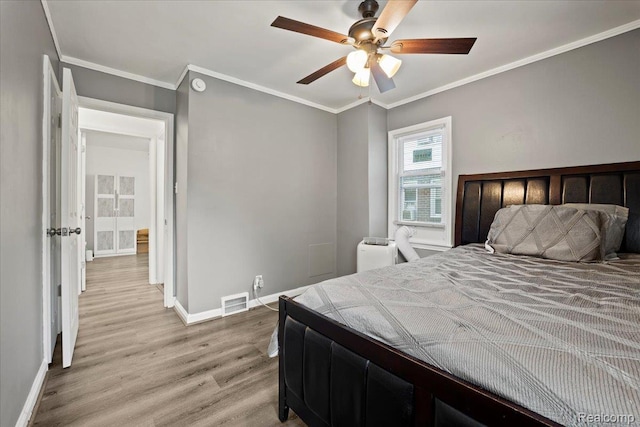 18247 Harlow St, Detroit, MI 48235 - bedroom with light wood-style flooring, ornamental molding, and ceiling fan
