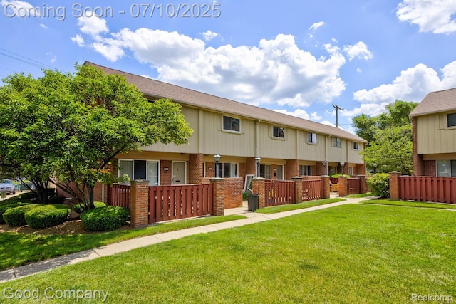 323 W Lincoln Ave, Royal Oak, MI 48067 - rear view of property featuring brick siding, a fenced front yard, and a gate