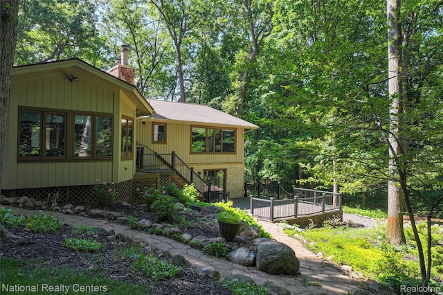 7500 Deerhill Dr, Clarkston, MI 48346 - view of front of property with a chimney and a deck