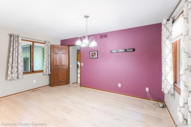7500 Deerhill Dr, Clarkston, MI 48346 - spare room featuring light wood-style floors and a chandelier
