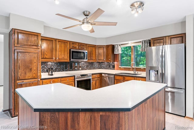 7500 Deerhill Dr, Clarkston, MI 48346 - kitchen with appliances with stainless steel finishes, backsplash, a ceiling fan, brown cabinets, and light countertops