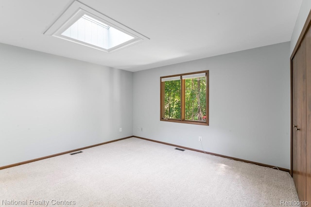 7500 Deerhill Dr, Clarkston, MI 48346 - unfurnished bedroom with a closet, a skylight, and carpet floors