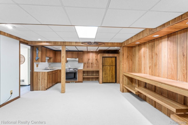 7500 Deerhill Dr, Clarkston, MI 48346 - bar area featuring light carpet, wooden walls, a paneled ceiling, stainless steel range oven, and under cabinet range hood
