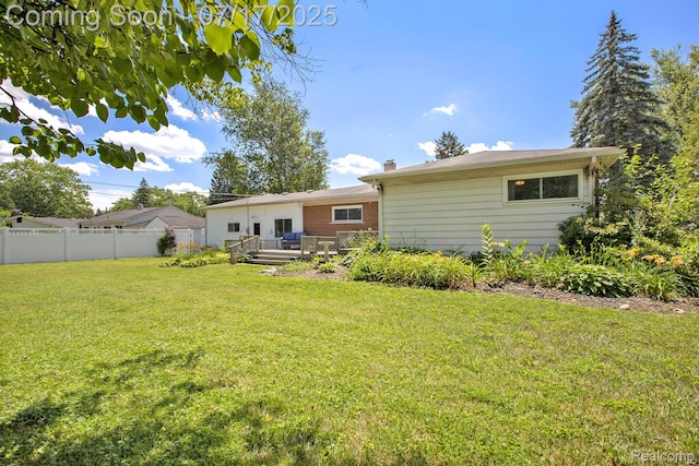 22950 Koths St, Taylor, MI 48180 - back of property with a wooden deck, a chimney, and brick siding