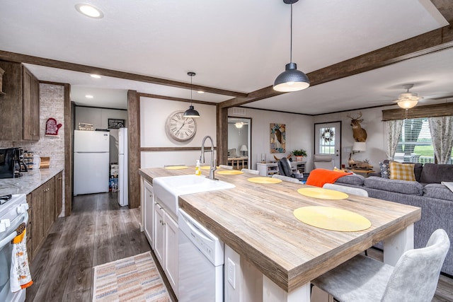 17648 Lost Lake Rd, Barryton, MI 49305 - kitchen with white appliances, beam ceiling, dark wood-type flooring, an island with sink, and white cabinets