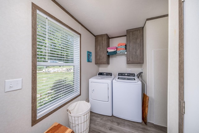 17648 Lost Lake Rd, Barryton, MI 49305 - laundry room with cabinet space, light wood-type flooring, washer and dryer, and healthy amount of natural light