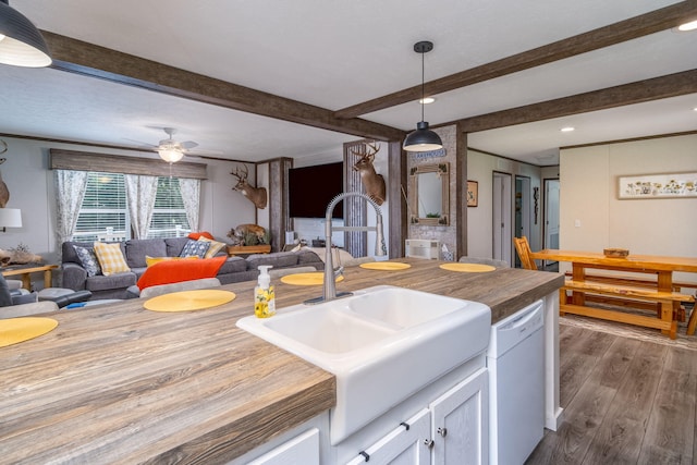17648 Lost Lake Rd, Barryton, MI 49305 - kitchen featuring white dishwasher, dark wood-style flooring, open floor plan, white cabinets, and beamed ceiling