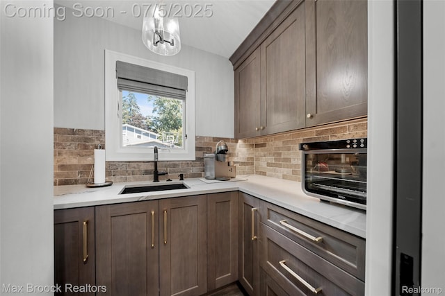 6907 W Knollwood Cir W, Bloomfield, MI 48322 - kitchen with backsplash, a chandelier, and light countertops