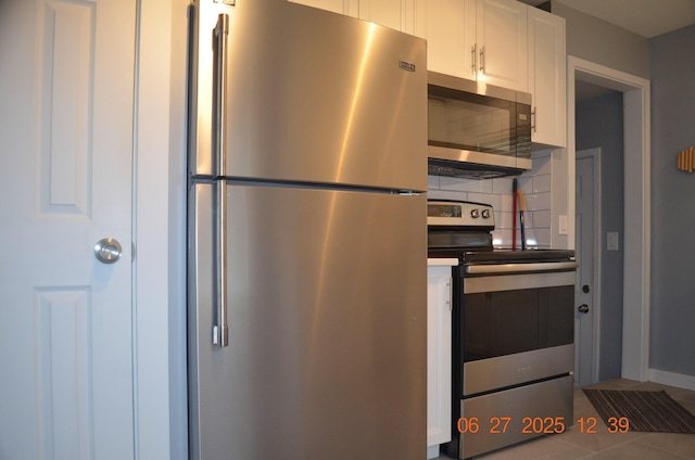 403 Hoover Ave, Benton Harbor, MI 49022 - kitchen with stainless steel appliances, white cabinets, backsplash, and tile patterned flooring