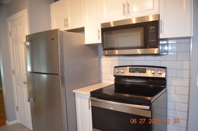 403 Hoover Ave, Benton Harbor, MI 49022 - kitchen with stainless steel appliances, white cabinetry, decorative backsplash, and light countertops