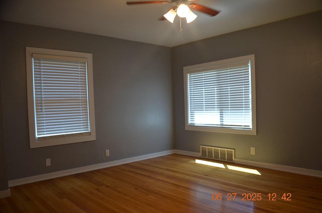 403 Hoover Ave, Benton Harbor, MI 49022 - empty room featuring a ceiling fan and wood finished floors