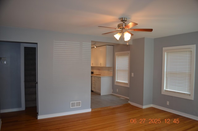 403 Hoover Ave, Benton Harbor, MI 49022 - unfurnished living room with a ceiling fan and light wood-type flooring
