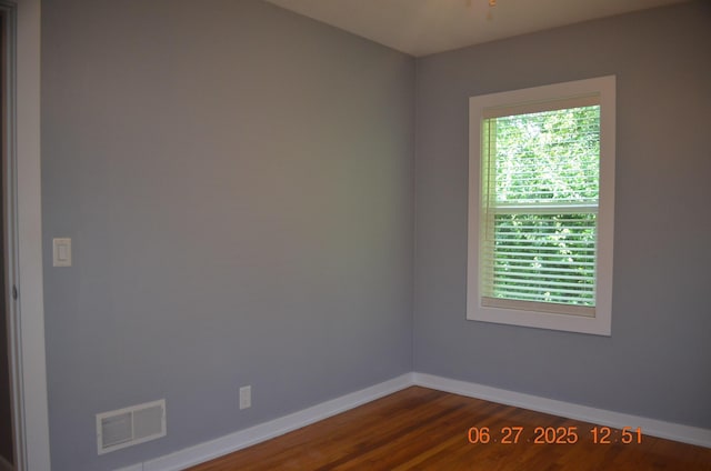 403 Hoover Ave, Benton Harbor, MI 49022 - unfurnished room with baseboards and dark wood-type flooring