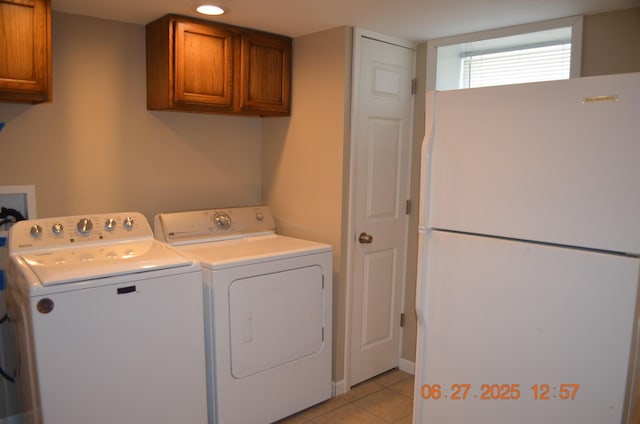 403 Hoover Ave, Benton Harbor, MI 49022 - laundry room with cabinet space, washer and clothes dryer, and light tile patterned floors