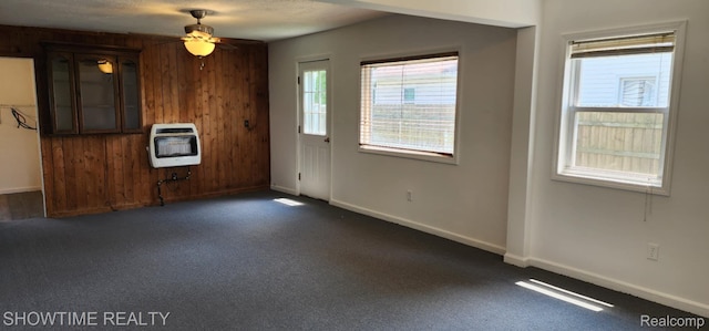 9825 Willow Ct, Clay, MI 48001 - unfurnished living room with heating unit, dark carpet, and a ceiling fan