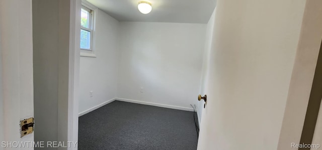 9825 Willow Ct, Clay, MI 48001 - spare room featuring dark carpet and baseboards