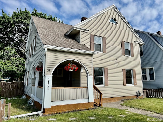 2109 Military St, Port Huron, MI 48060 - traditional home featuring roof with shingles, covered porch, and a chimney